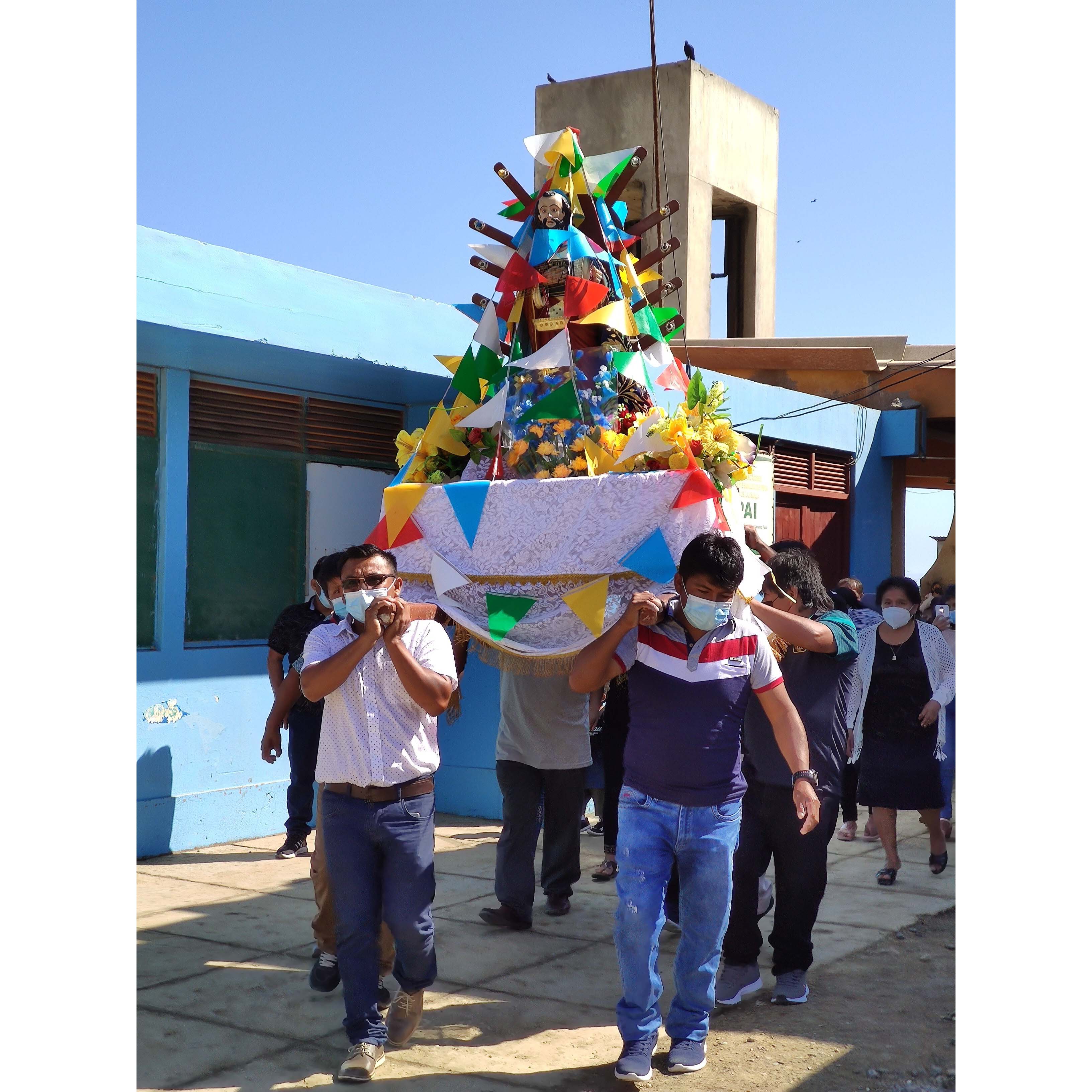 community members in Piura, Peru carrying San Pedro statue